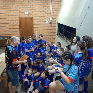 Equipe Feminina ouvindo o técnico